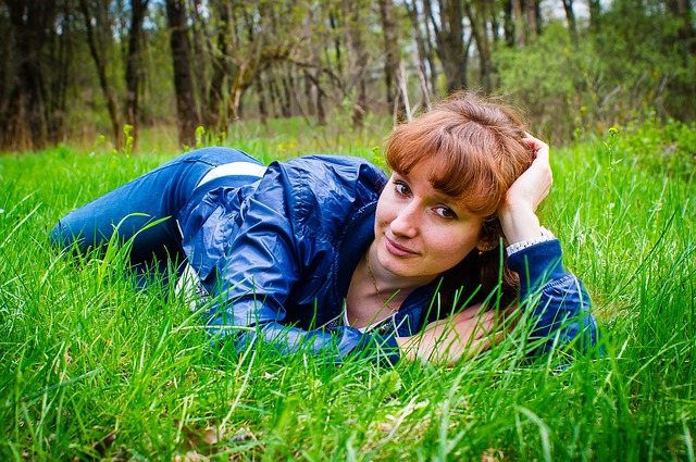 beautiful girl lying in grass